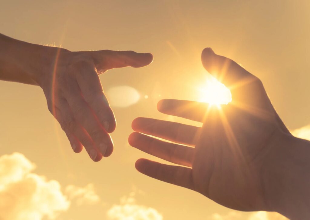 A helping hand with the sun shining in the background. We hope this is how you feel when we guide you through our tips on how to apply for an SEAI Solar grant (with SolarSmart).