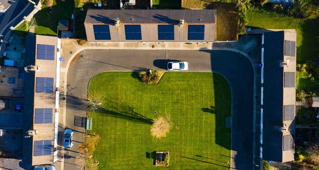 A bird's eye view of the retrofitted College View apartments with solar panels on them.