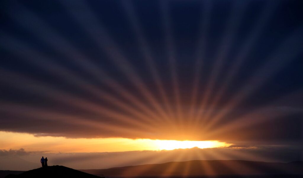 The sun shining through the clouds, ready to be used to generate solar power in Ireland.