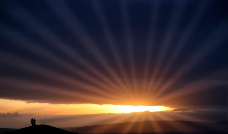 The sun shining through the clouds, ready to be used to generate solar power in Ireland.