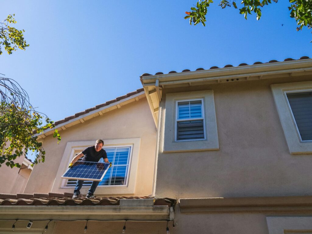 A man installing solar panels which the homeowners can afford with the new Home Energy Upgrade Loan Scheme in Ireland.